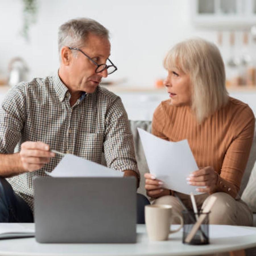 stressed senior couple reviewing timeshare cancellation contract