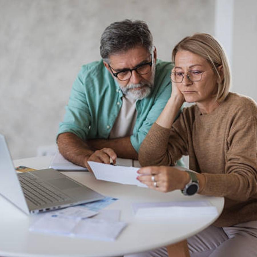 senior couple reviewing a timeshare cancellation contract
